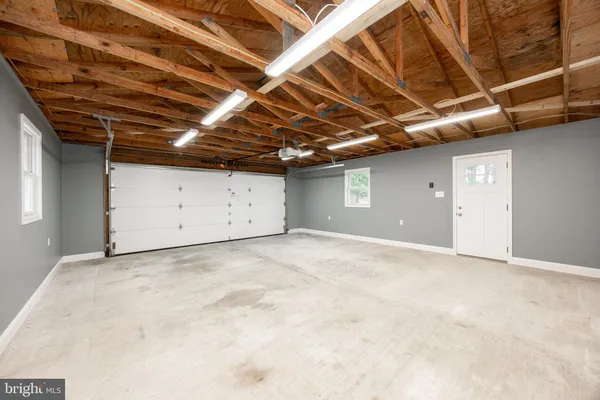 a view of a house with a yard covered in snow