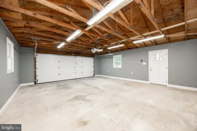 a view of a house with a yard covered in snow