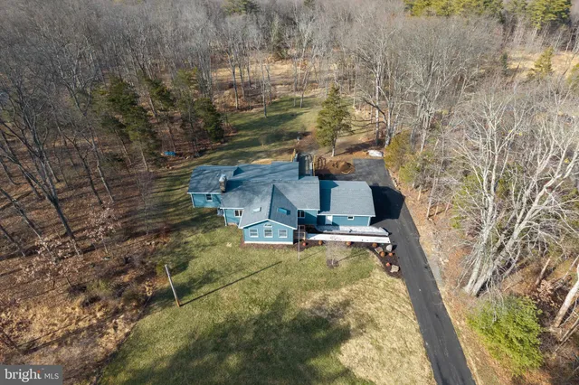 a brick house with a large window and yard