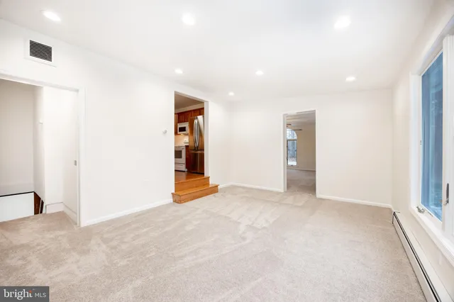 an empty room with a empty space and windows