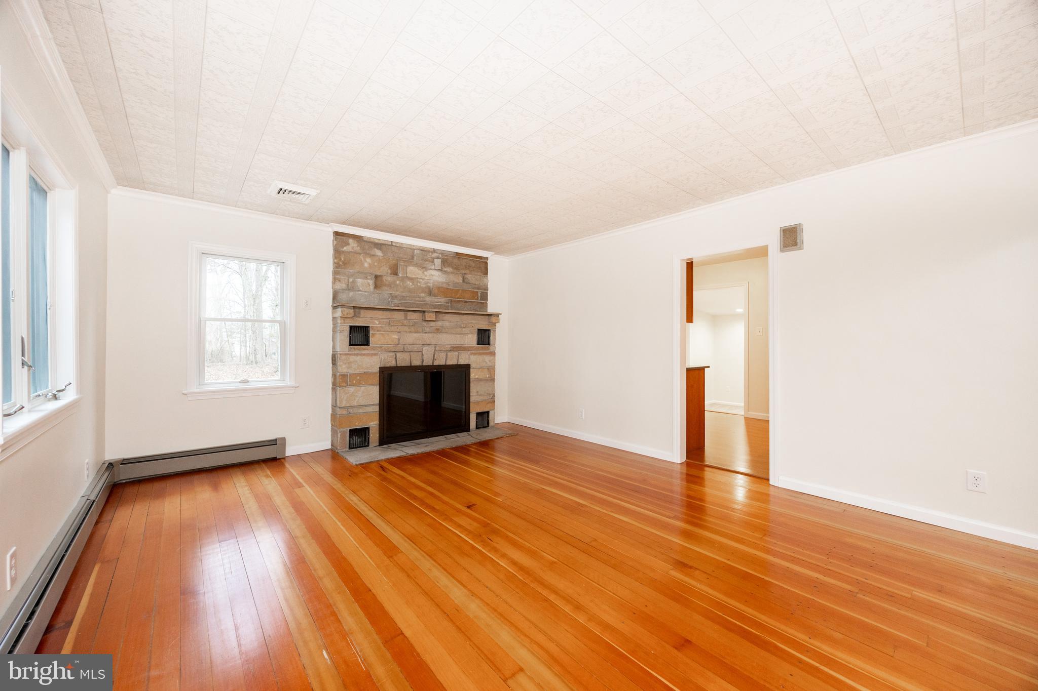 5816 Upper Ridge Road Pennsburg, PA 18073 - Photo 9 of 71 a view of empty room with wooden floor and fireplace