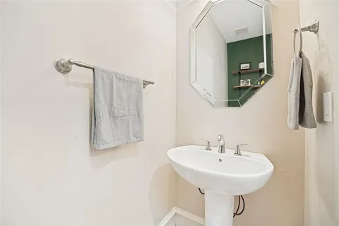 a bathroom with a sink a mirror and shower