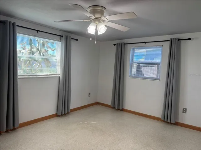 a view of an empty room with a fan