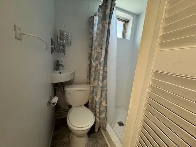 a utility room with dryer washer and a sink