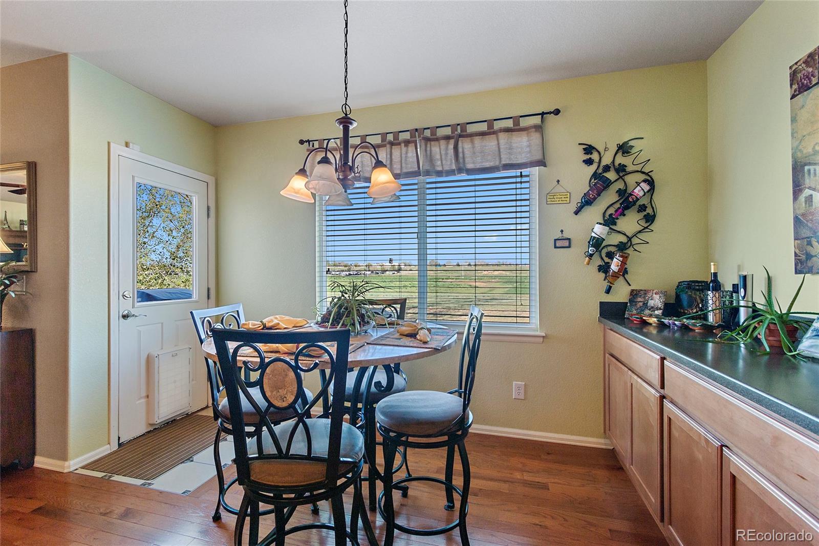 8151 Raspberry Drive Frederick, CO 80504 - Photo 11 of 35 a view of a dining room with furniture window and wooden floor