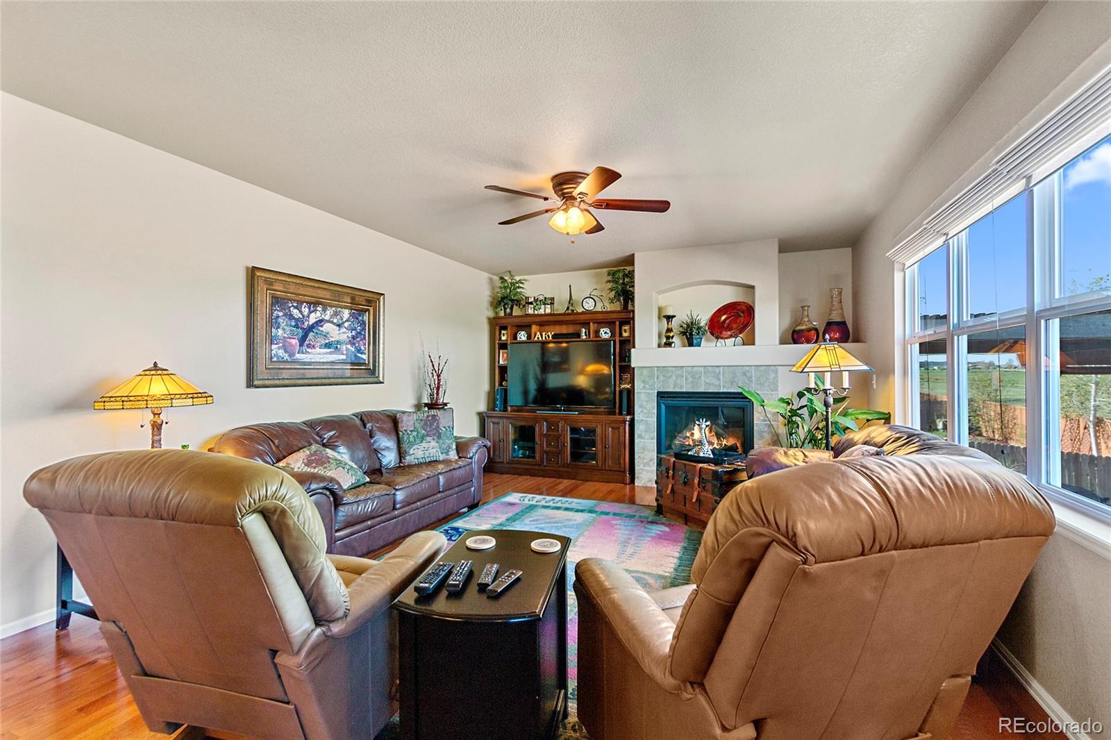 8151 Raspberry Drive Frederick, CO 80504 - Photo 13 of 35 a living room with furniture a fireplace and a window