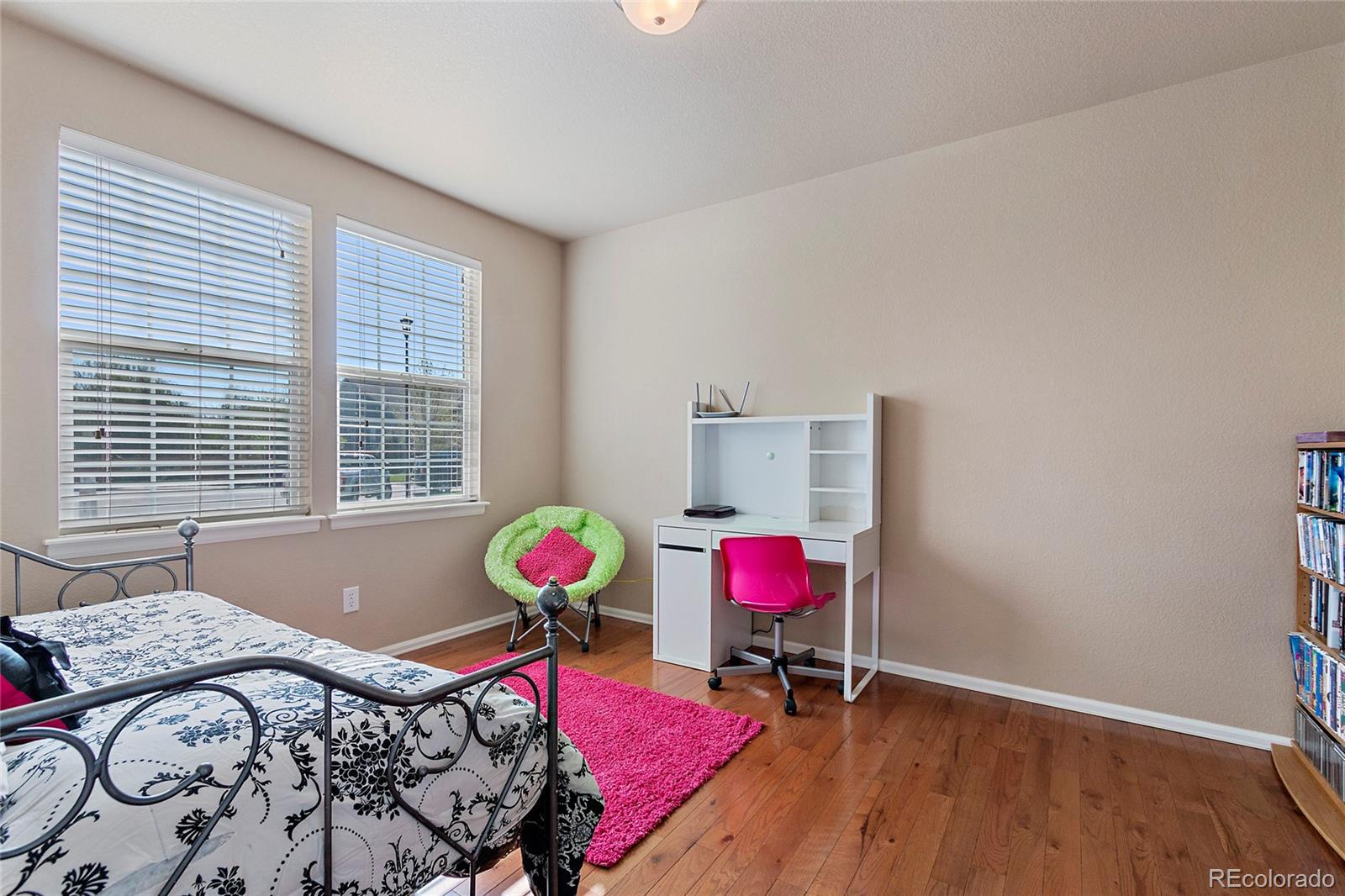 8151 Raspberry Drive Frederick, CO 80504 - Photo 15 of 35 a bedroom with a bed and wooden floor