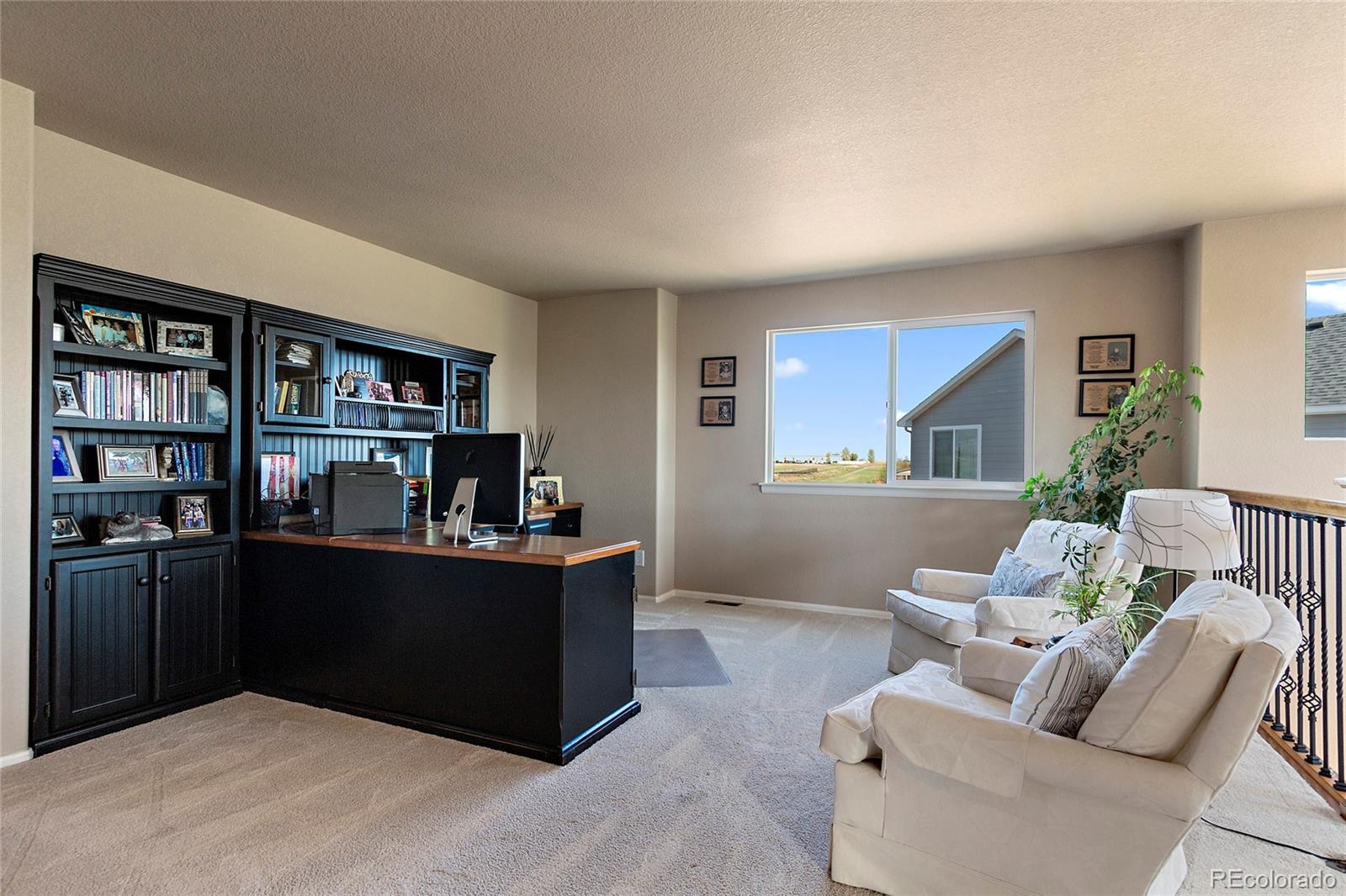 8151 Raspberry Drive Frederick, CO 80504 - Photo 18 of 35 a living room with furniture and a bookshelf