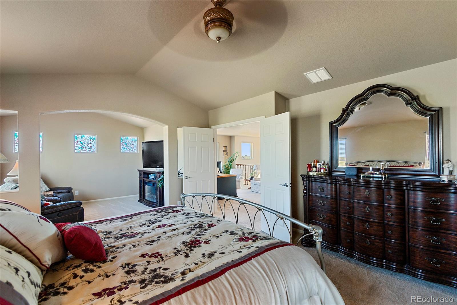8151 Raspberry Drive Frederick, CO 80504 - Photo 20 of 35 a bedroom with a bed and wooden floor