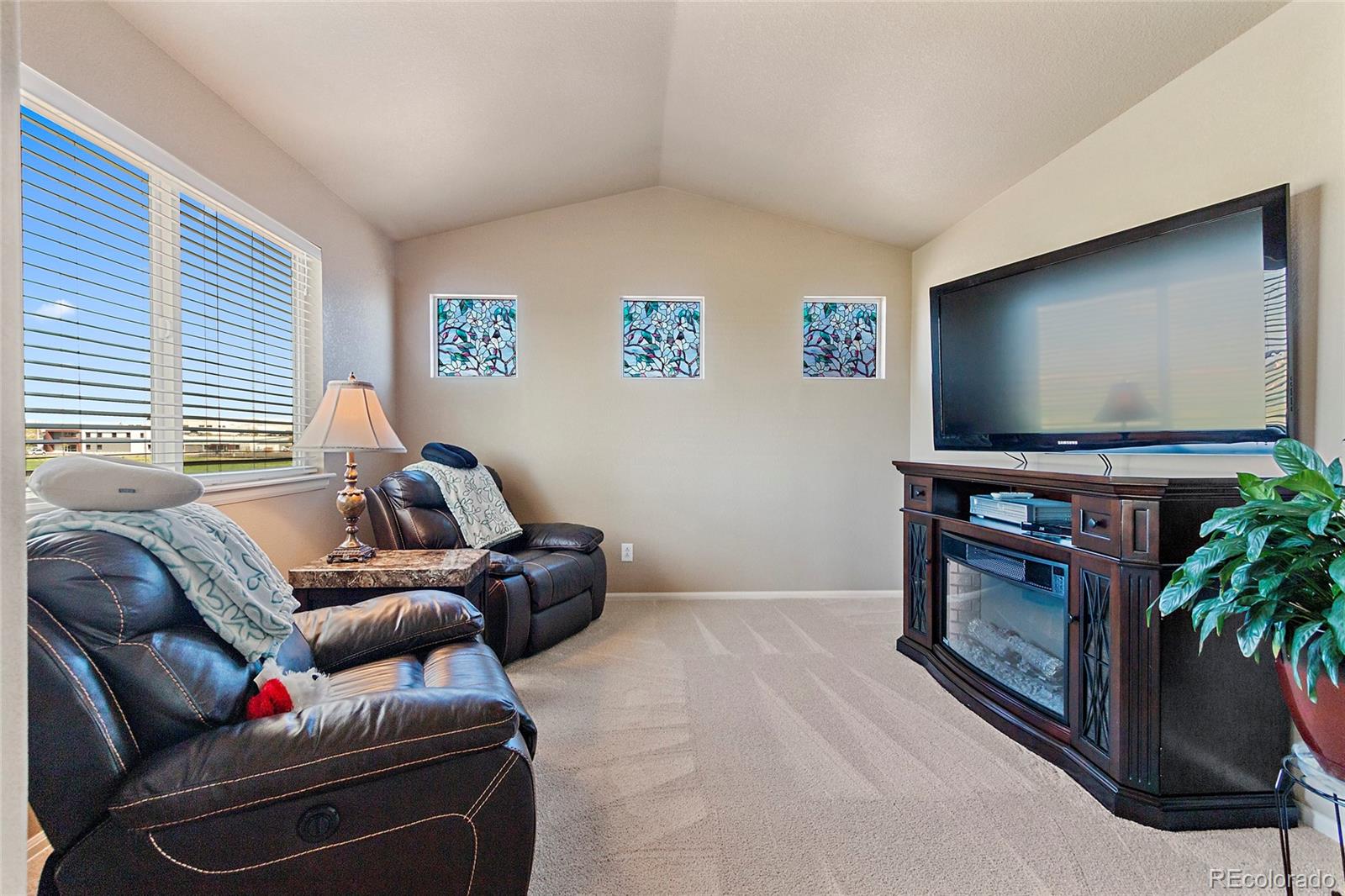 8151 Raspberry Drive Frederick, CO 80504 - Photo 21 of 35 a living room with furniture and a flat screen tv