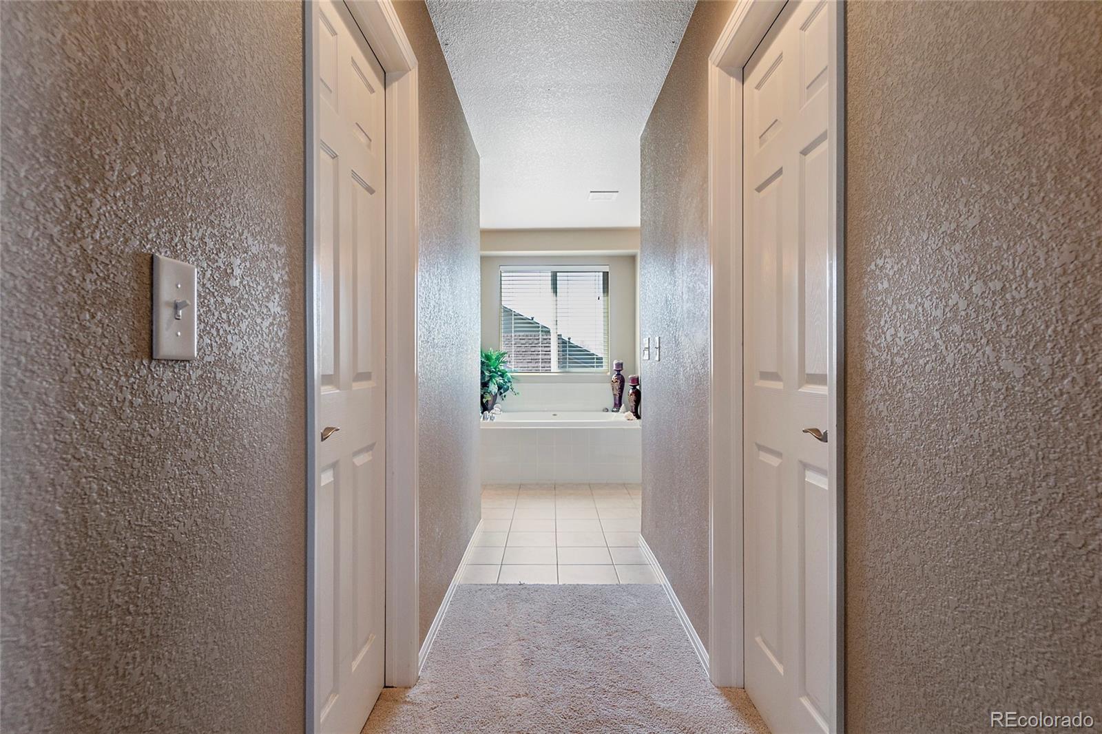 8151 Raspberry Drive Frederick, CO 80504 - Photo 22 of 35 a view of a hallway with a wooden door