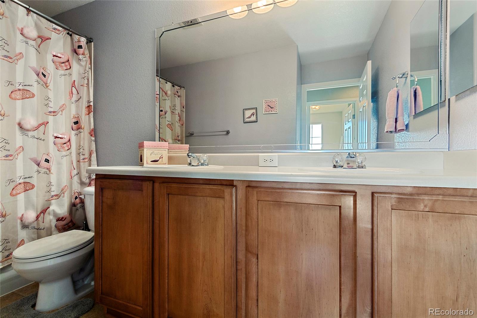 8151 Raspberry Drive Frederick, CO 80504 - Photo 27 of 35 a bathroom with a granite countertop sink toilet and mirror
