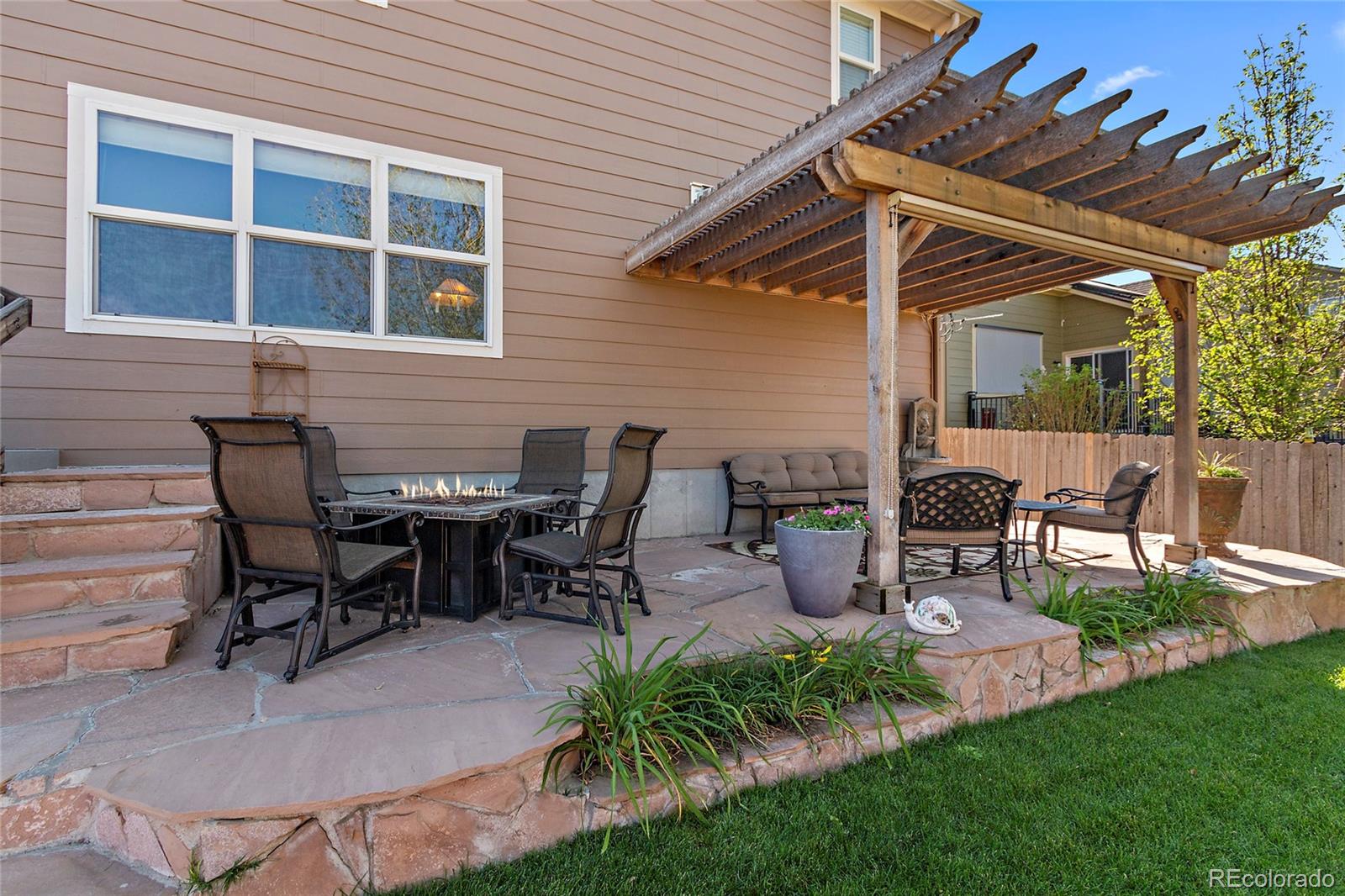 8151 Raspberry Drive Frederick, CO 80504 - Photo 30 of 35 a view of a patio with table and chairs and potted plants