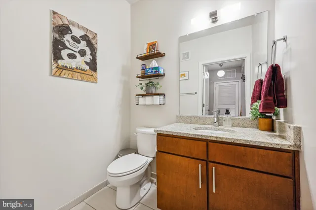 a kitchen with stainless steel appliances granite countertop a sink a stove and refrigerator