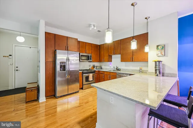 a living room with furniture and a view of kitchen