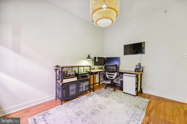 a living room with furniture a flat screen tv and a floor to ceiling window