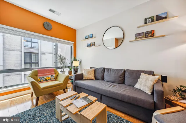 a spacious bedroom with a bed and table chair