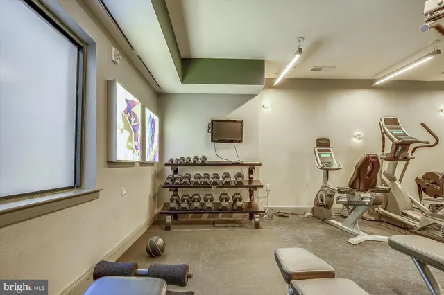 a living room with fireplace furniture and floor to ceiling window