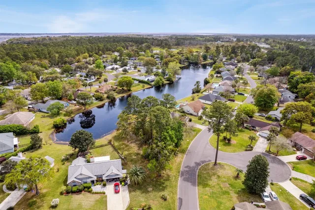 an aerial view of residential houses with outdoor space