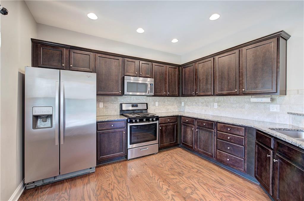 25 Winter Pointe Northwest Cartersville, GA 30121 - Photo 13 of 43 a kitchen with stainless steel appliances granite countertop a refrigerator and a stove top oven