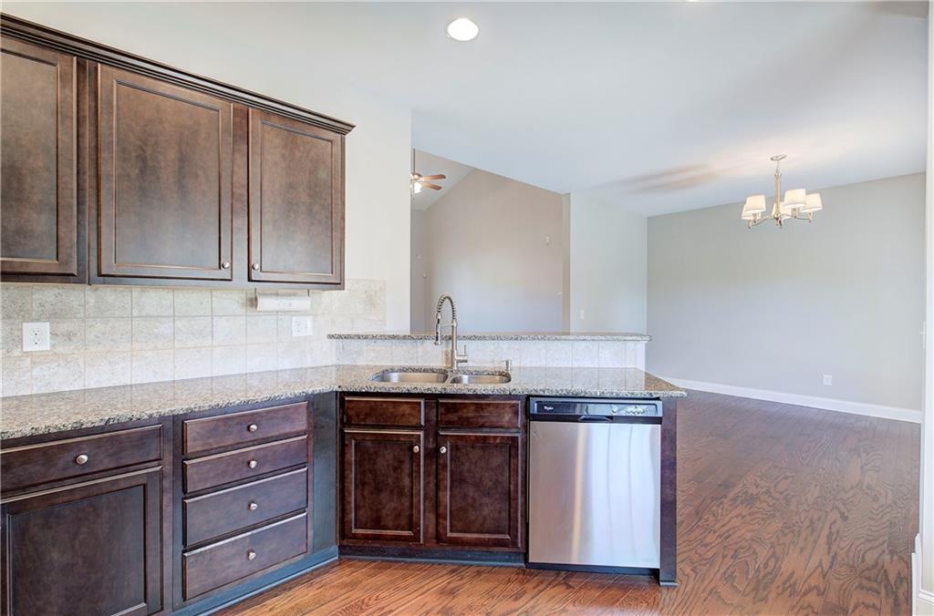 25 Winter Pointe Northwest Cartersville, GA 30121 - Photo 15 of 43 a kitchen with granite countertop a sink cabinets and stainless steel appliances
