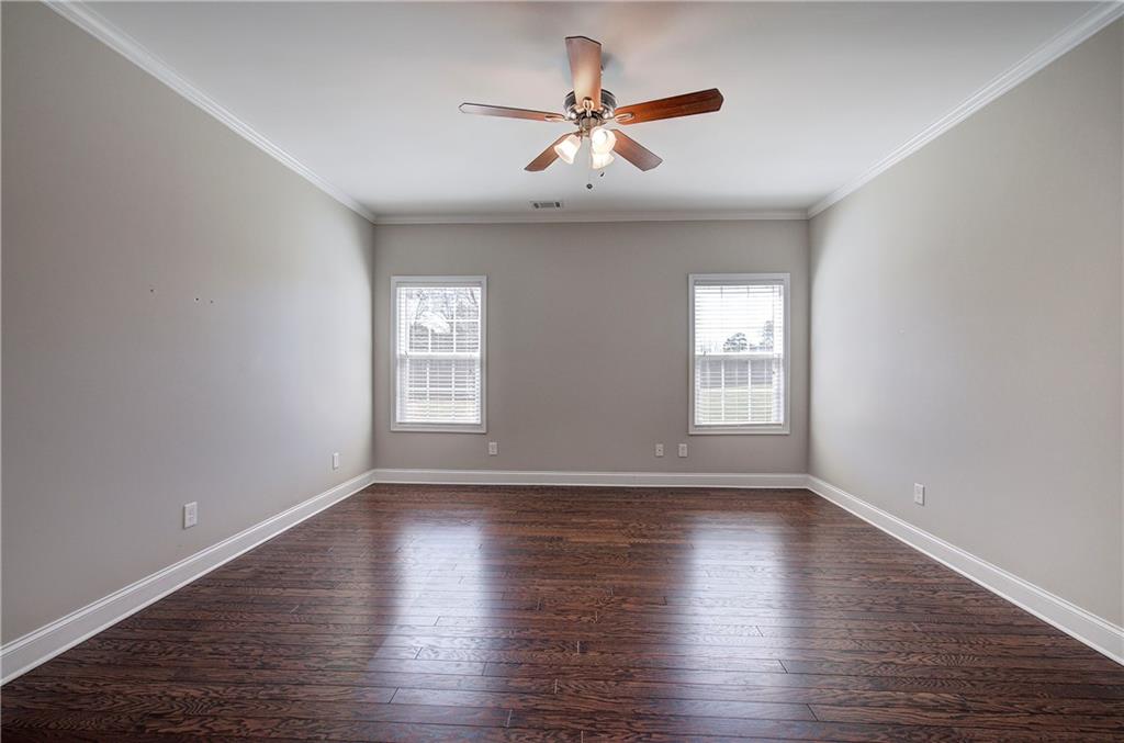 25 Winter Pointe Northwest Cartersville, GA 30121 - Photo 18 of 43 a view of an empty room with wooden floor and a window