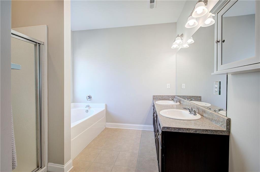 25 Winter Pointe Northwest Cartersville, GA 30121 - Photo 19 of 43 a spacious bathroom with a granite countertop sink a mirror and a bathtub