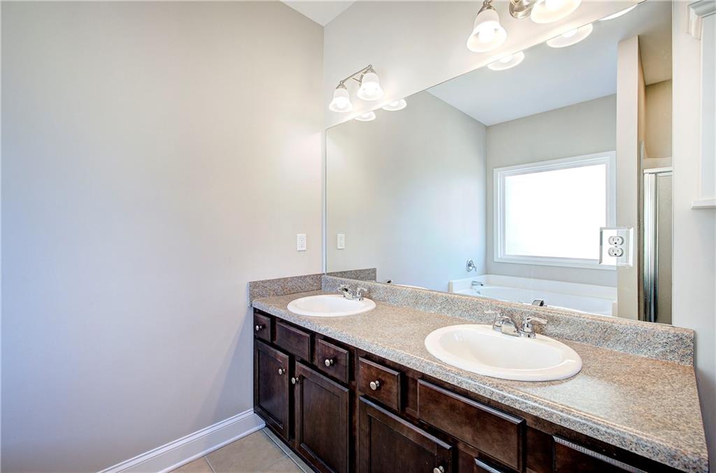25 Winter Pointe Northwest Cartersville, GA 30121 - Photo 21 of 43 a bathroom with a granite countertop sink and a mirror