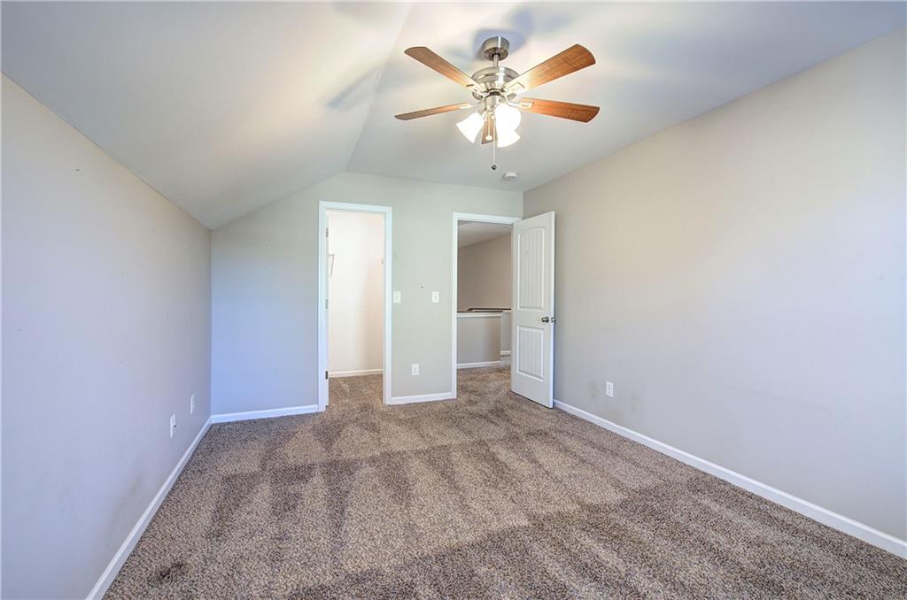 25 Winter Pointe Northwest Cartersville, GA 30121 - Photo 30 of 43 an empty room with a chandelier fan and windows