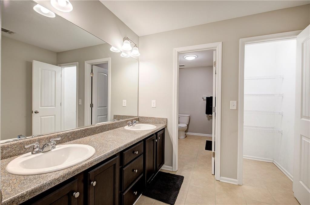 25 Winter Pointe Northwest Cartersville, GA 30121 - Photo 31 of 43 a spacious bathroom with a granite countertop double vanity sink a mirror and a