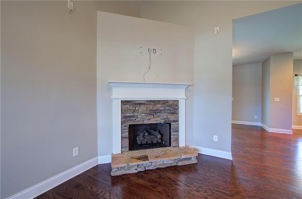 25 Winter Pointe Northwest Cartersville, GA 30121 - Photo 7 of 43 a living room with a fireplace and wooden floor