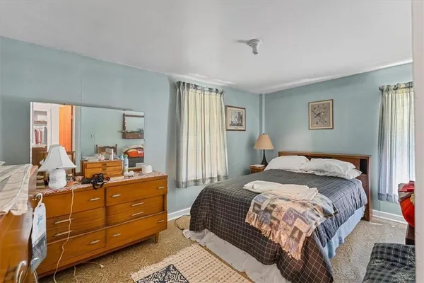 a bedroom with furniture and a window