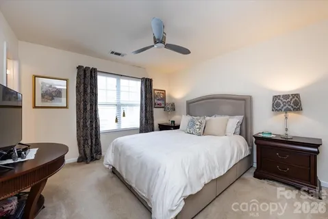 a bedroom with a bed and a table