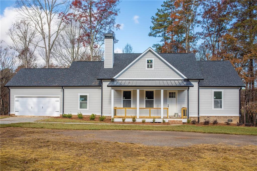7785 Bill Wilson Road Alto, GA 30510 - Photo 1 of 1 a front view of a house with a yard