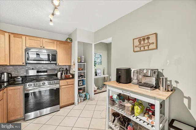 a kitchen with a stove and a microwave