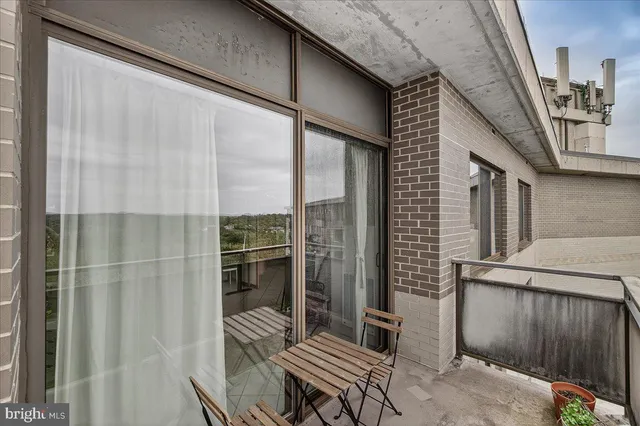 a view of balcony with wooden floor and outdoor seating