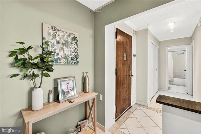 a view of living room with furniture and a potted plant