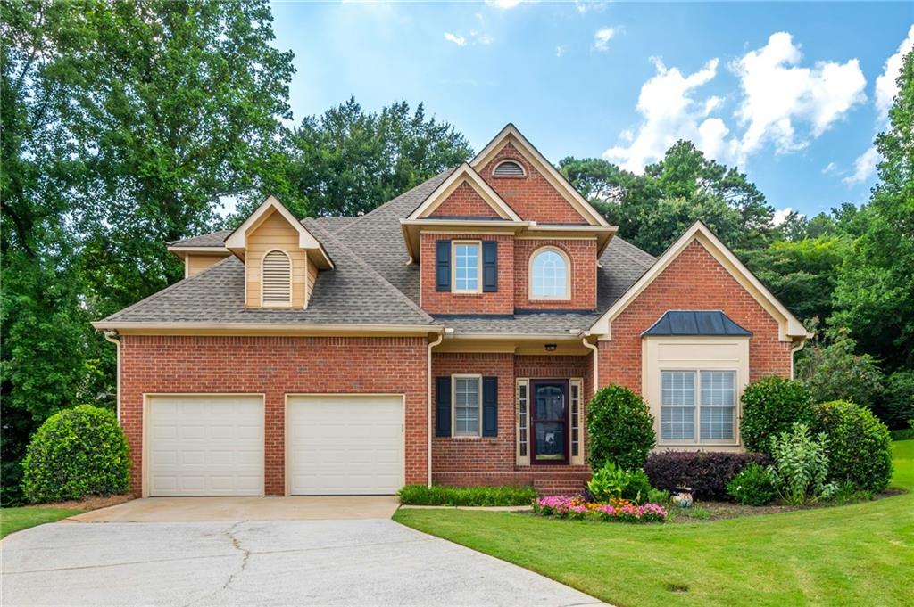 1035 Lancaster Walk Northwest Atlanta, GA 30328 - Photo 1 of 1 a front view of a house with garden