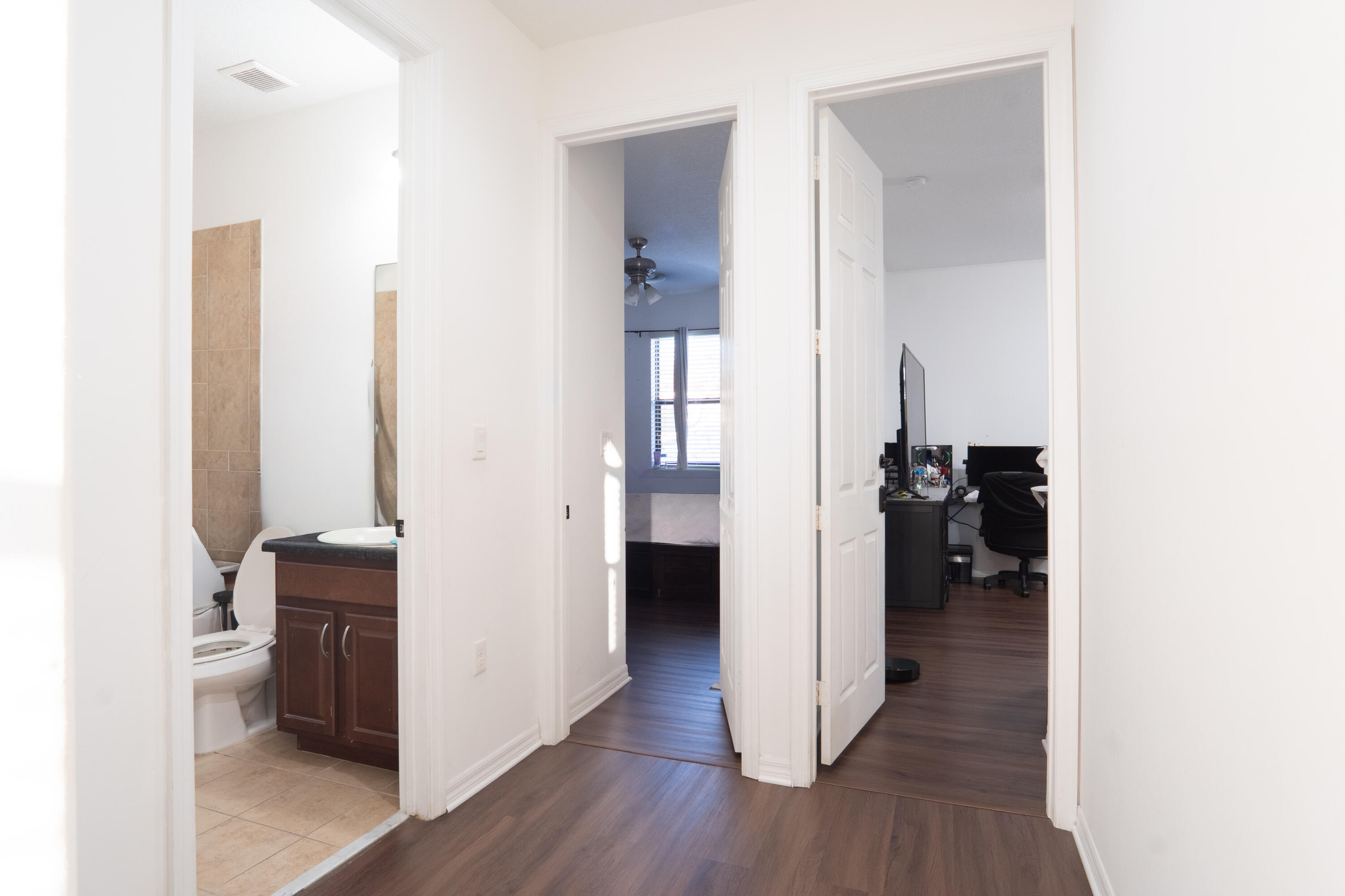 3573 Southwest 92nd Avenue Miramar, FL 33025 - Photo 13 of 24 a view of a hallway with wooden floor and a bathroom