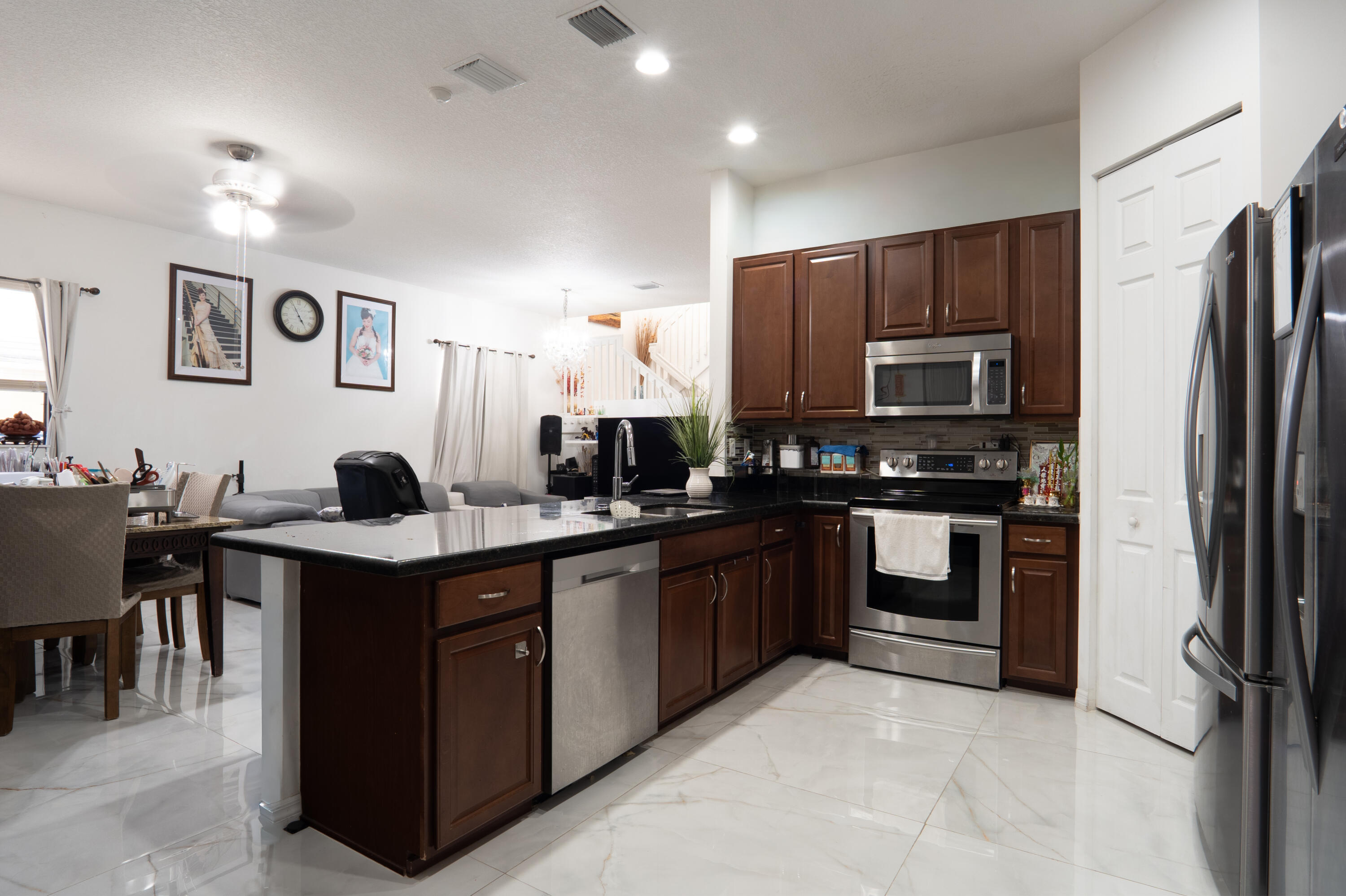 3573 Southwest 92nd Avenue Miramar, FL 33025 - Photo 9 of 24 a kitchen with stainless steel appliances granite countertop a refrigerator and a stove top oven