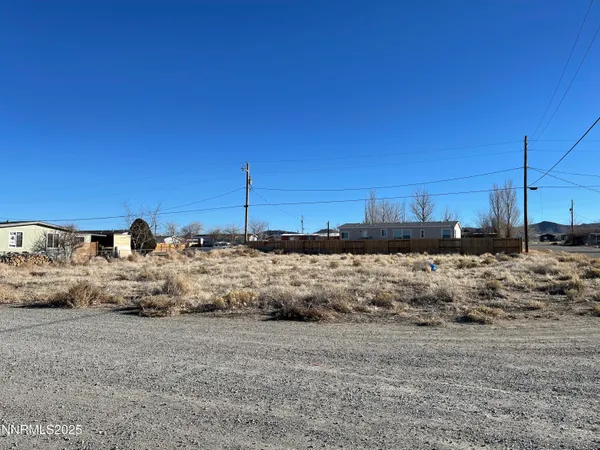 a view of a dry yard covered with snow