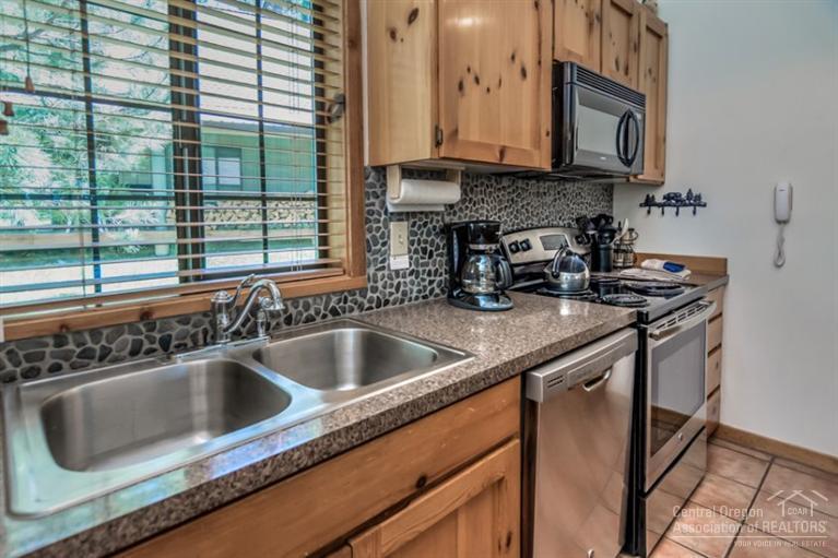 22 Circle 4 Ranch Circle Sunriver, OR 97707 - Photo 13 of 25 a kitchen with a sink cabinets and a window