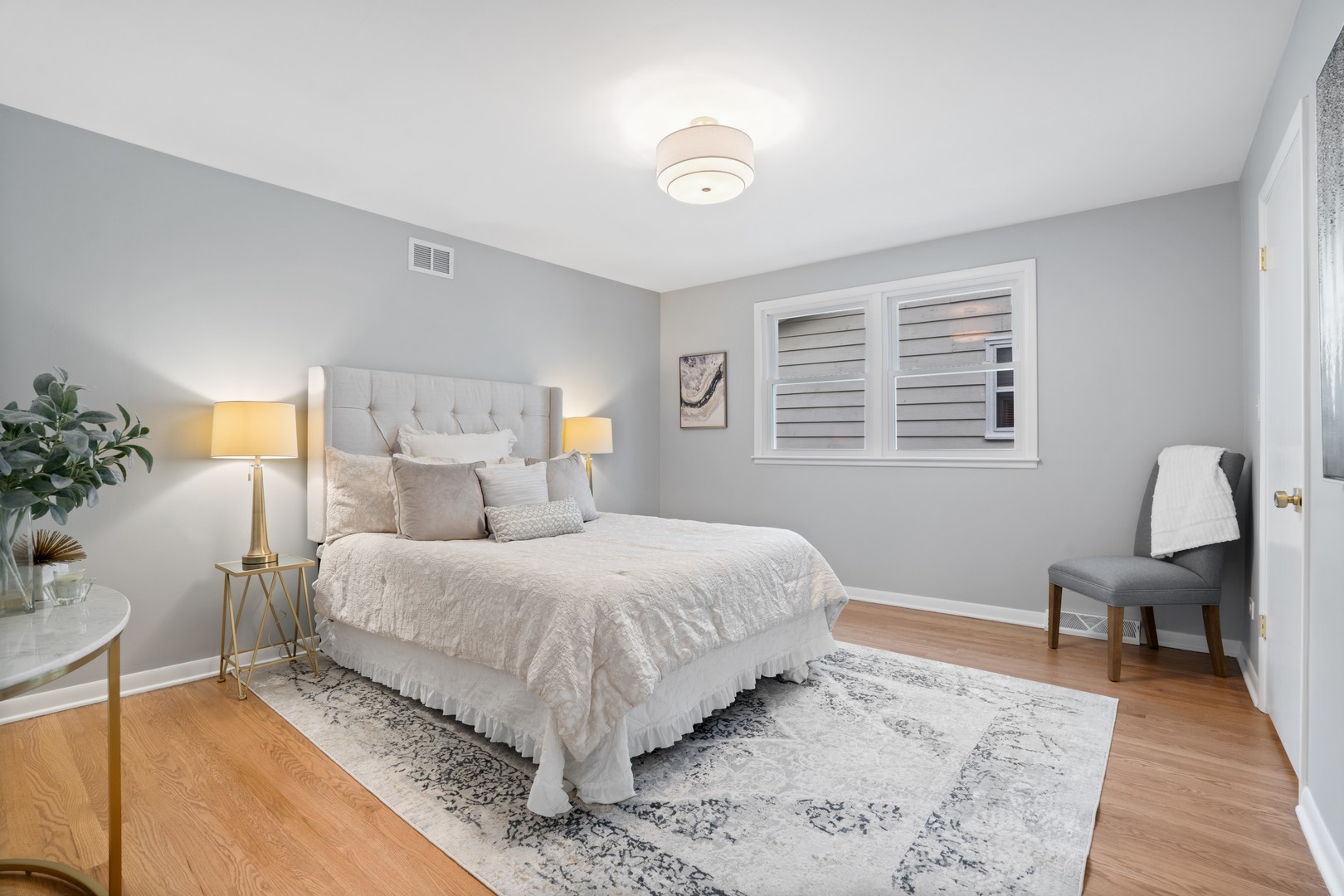 215 45th Street Western Springs, IL 60558 - Photo 25 of 46 a bedroom with a bed wooden floor and a potted plant