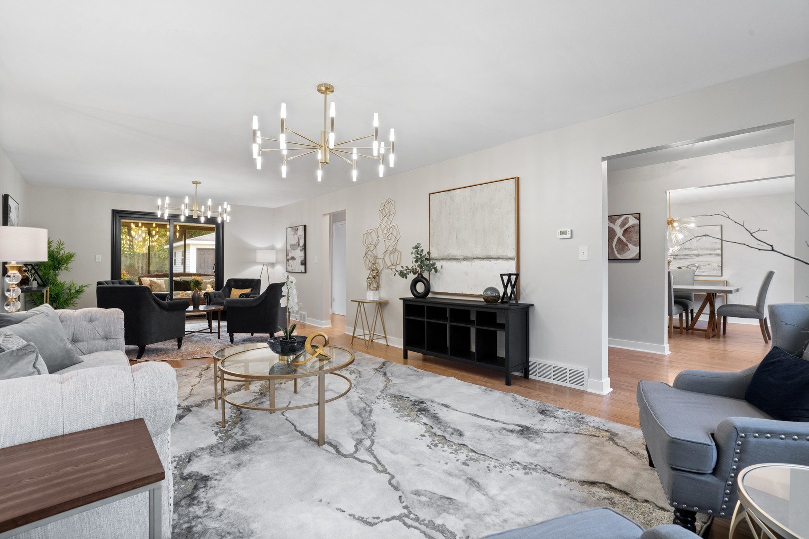 215 45th Street Western Springs, IL 60558 - Photo 7 of 46 a living room with furniture a fireplace and a chandelier