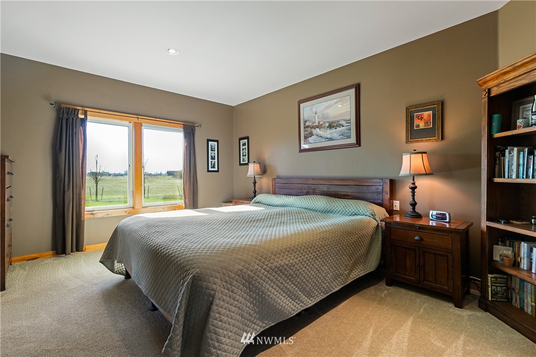 2693 Lindsay Road Everson, WA 98247 - Photo 20 of 40 a bedroom with a bed bookshelf and a large window