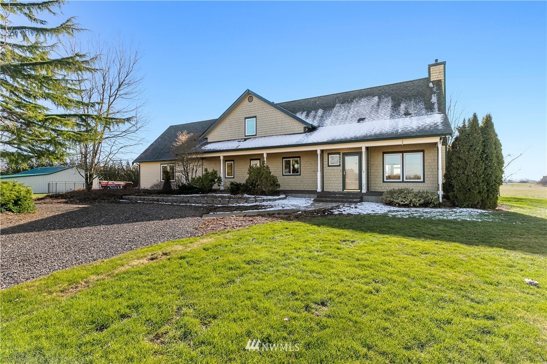 2693 Lindsay Road Everson, WA 98247 - Photo 3 of 40 a front view of a house with swimming pool yard and glass windows