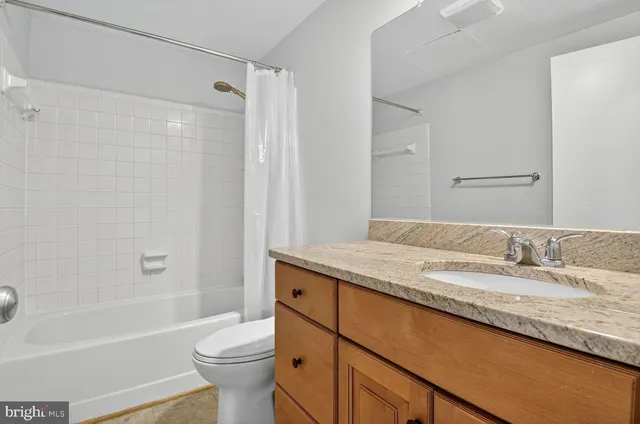 a bathroom with a granite countertop sink mirror and a