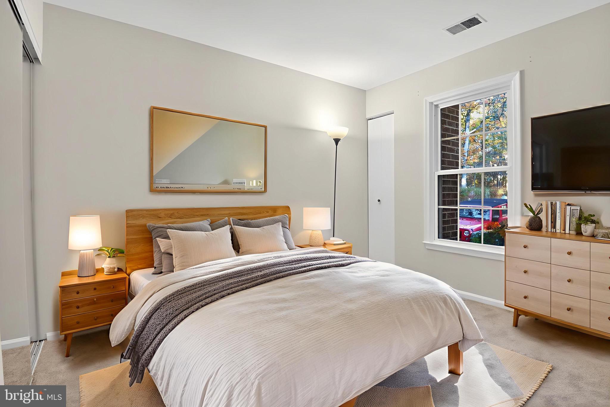 11116 Beaver Trail Court, Unit 11116 Reston, VA 20191 - Photo 14 of 28 a bedroom with a bed and a flat tv screen on dresser