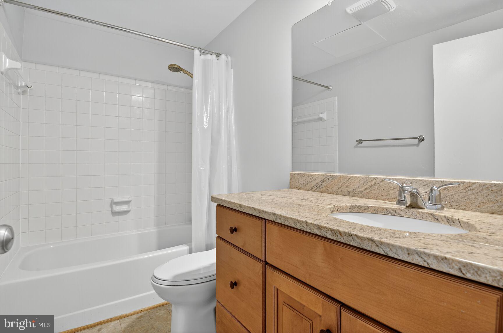 11116 Beaver Trail Court, Unit 11116 Reston, VA 20191 - Photo 19 of 28 a bathroom with a granite countertop sink a toilet and shower