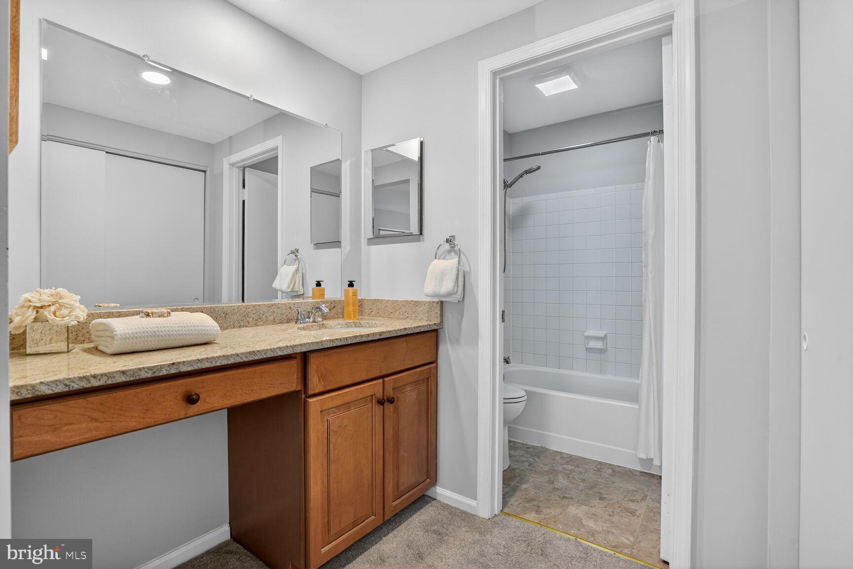 11116 Beaver Trail Court, Unit 11116 Reston, VA 20191 - Photo 25 of 28 a bathroom with a granite countertop sink and a mirror
